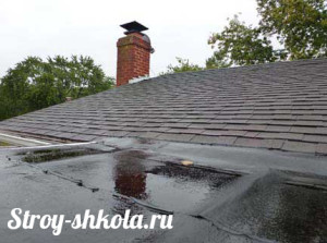 Процесс промазывания крыши битумной мастикой